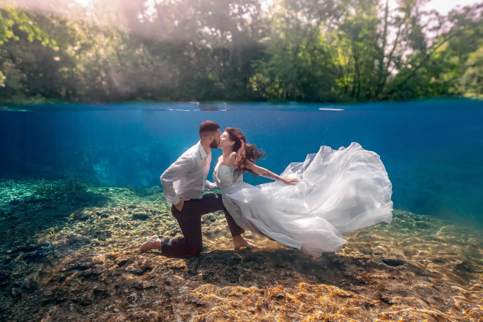 A split-shot photo of an elopement couple embracing and kissing underwater at Kelly Rock Park in Apopka Florida